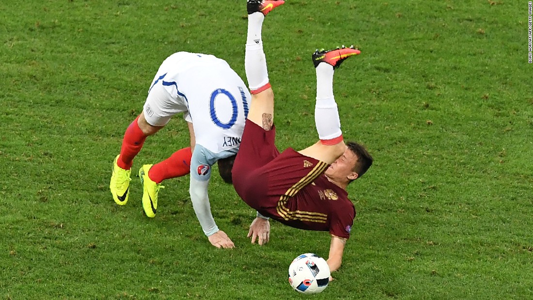 England forward Wayne Rooney, left, collides with Russia midfielder Aleksandr Golovin.