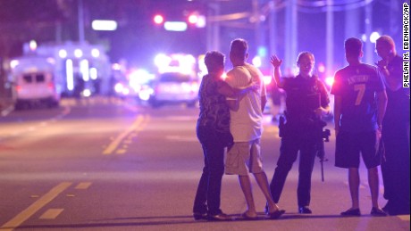 Orlando Police officers direct family members away from a multiple shooting at a nightclub in Orlando, Fla., Sunday, June 12, 2016. A gunman opened fire at a nightclub in central Florida, and multiple people have been wounded, police said Sunday. 