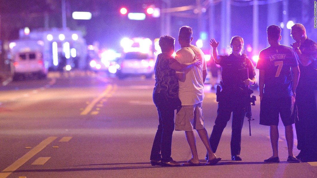 Police in Orlando direct family members away from the scene of the shooting.