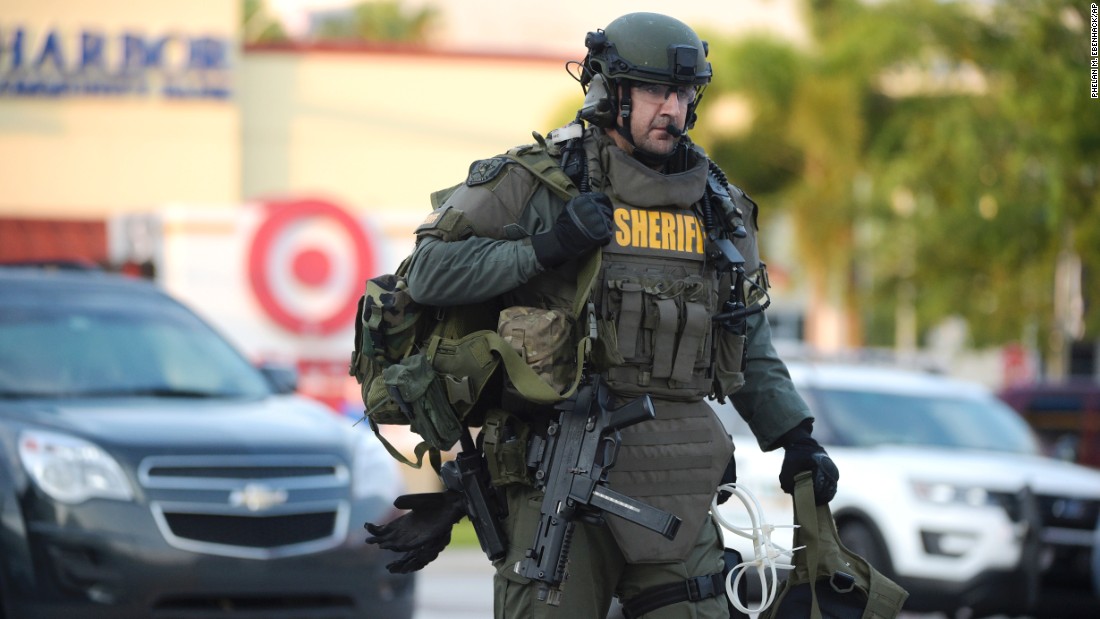 A SWAT team member arrives at the scene of the shooting.