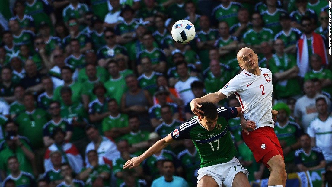 Northern Ireland&#39;s Paddy McNair, left, vies for the ball with Poland&#39;s Michal Pazdan. 