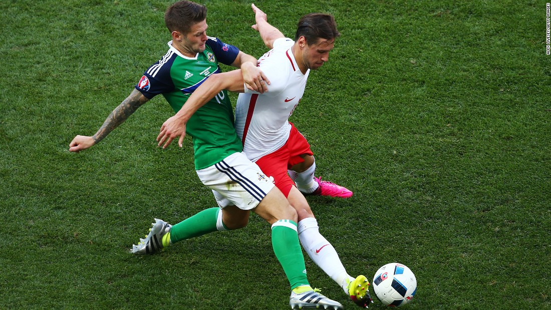 Poland&#39;s Grzegorz Krychowiak, right, competes for the ball with Northern Ireland&#39;s Oliver Norwood.