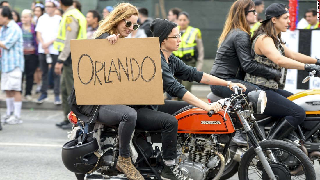 People show their support for Orlando during the Los Angeles gay pride parade.