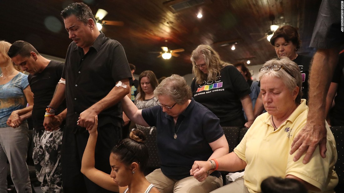 A man injured in the attack stands with other mourners as they attend a memorial service at an Orlando church.