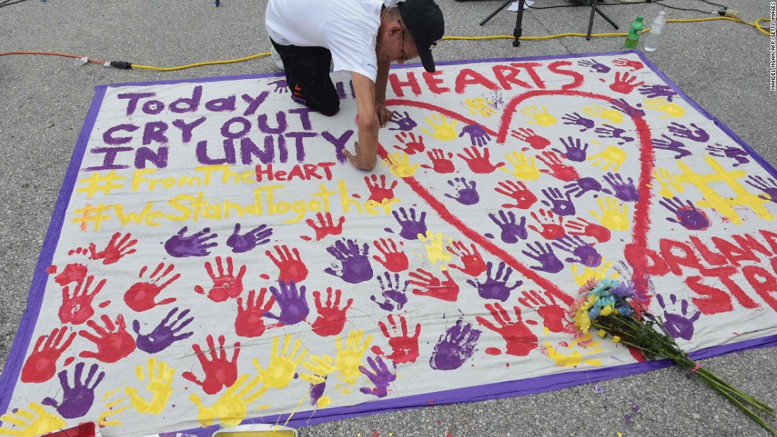 A man places a handprint on a makeshift memorial near the nightclub where the attack took place.