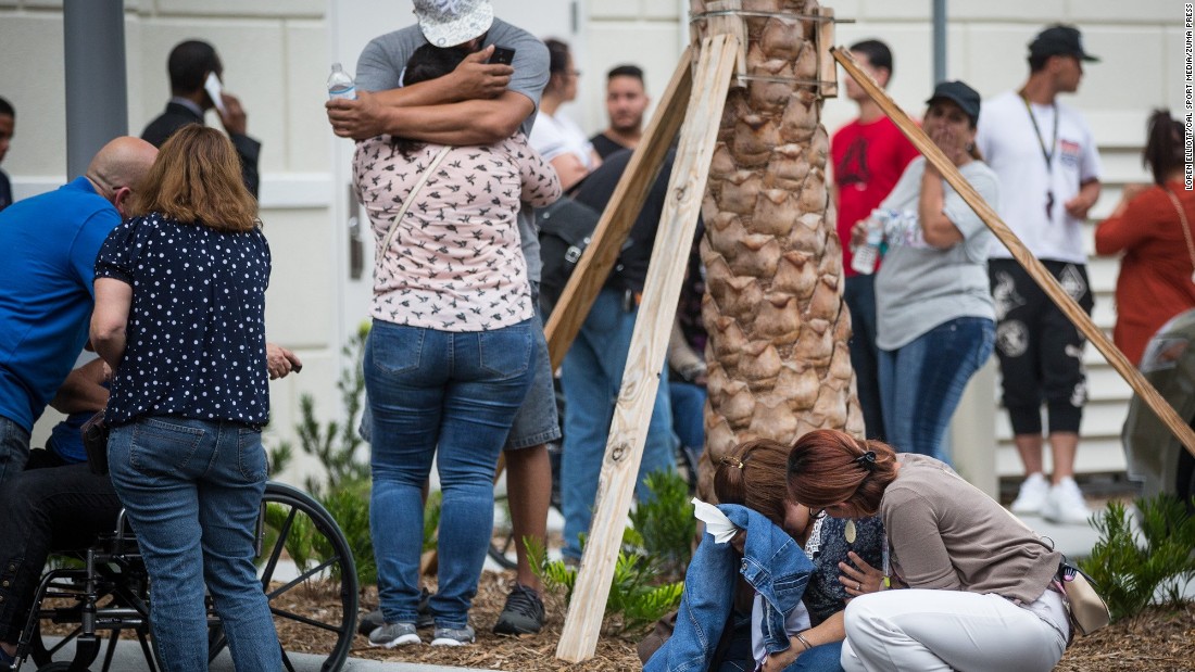 Friends and family react after a list of hospitalized victims is released June 12 outside a hotel near the Orlando Regional Medical Center.