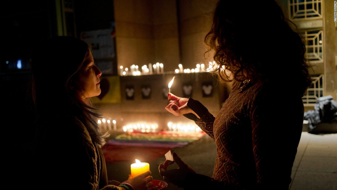 Two women light candles during a vigil in front of the U.S. Embassy in Santiago, Chile, on June 12. 