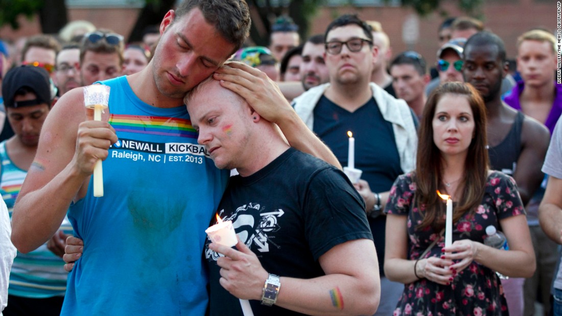 Ryan Gibson, left, embraces Tabor Winstead during a vigil in Raleigh, North Carolina, on June 12.