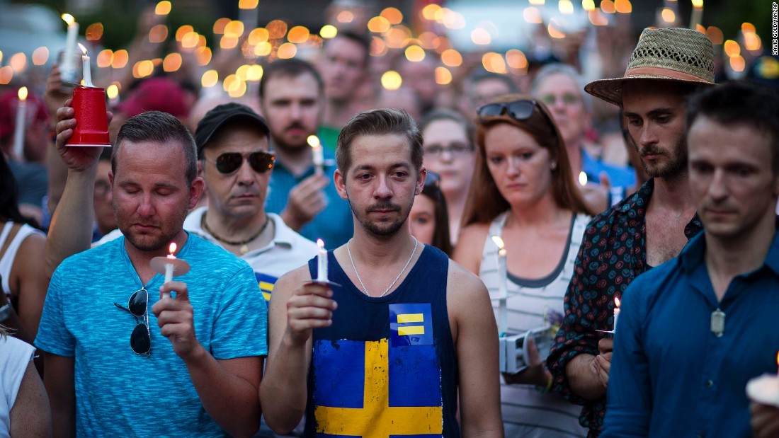 Mourners observe a moment of silence during a vigil in Atlanta.