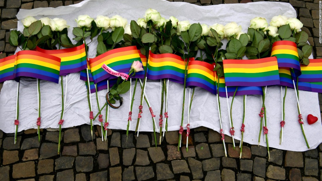 White roses and rainbow flags are displayed in front of the U.S. Embassy in Berlin on June 13.