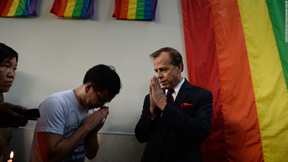 U.S. Ambassador to Thailand Glyn T. Davies, right, gestures to members of the LGBT community outside the U.S. Embassy in Bangkok, Thailand, on June 13. They were holding a vigil for the victims.