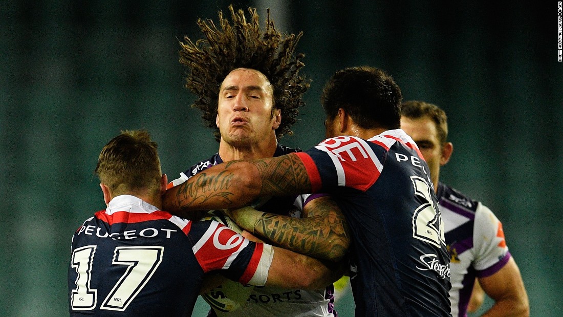 Kevin Proctor of the Melbourne Storm is tackled by Sydney Roosters during a National Rugby League match in Sydney on Saturday, June 11.
