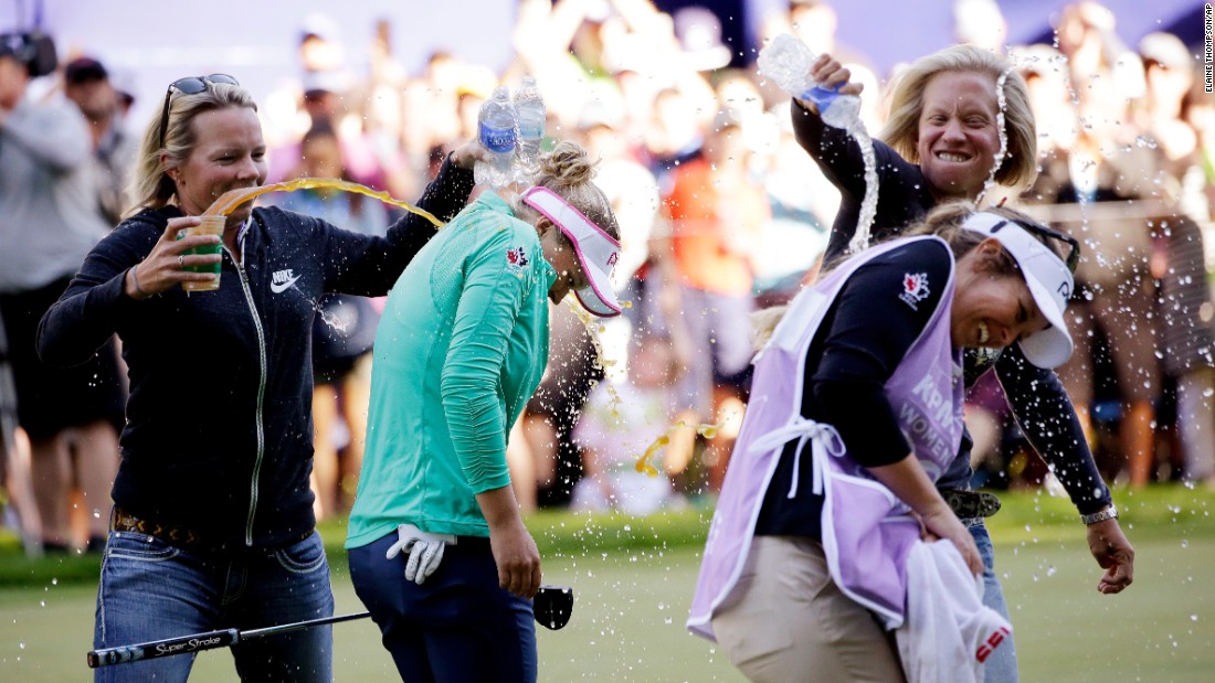 Pro golfer Brooke Henderson, second from left, is doused after &lt;a href=&quot;http://www.cnn.com/2016/06/13/golf/golf-lydia-ko-brooke-henderson/&quot; target=&quot;_blank&quot;&gt;winning the Women&#39;s PGA Championship&lt;/a&gt; on Sunday, June 12. In front of her is her caddie and sister, Brittany. Henderson, 18, defeated world No. 1 Lydia Ko in a playoff.
