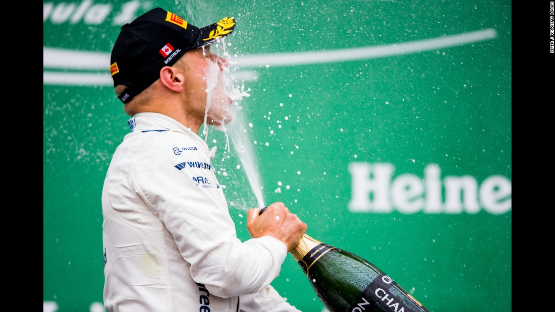 Formula One driver Valtteri Bottas sprays himself with champagne after finishing third at the Canadian Grand Prix on Sunday, June 12. 