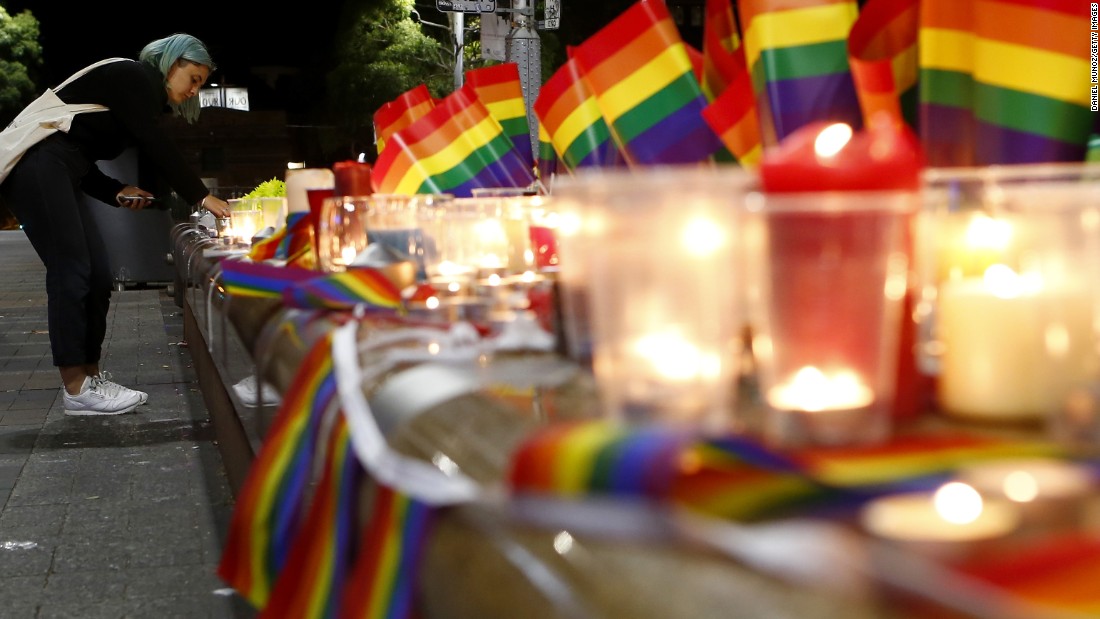 A woman lights a candle during a vigil in Sydney on June 13.