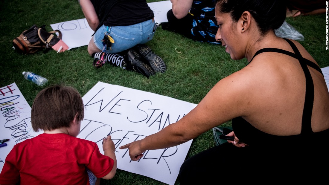 Attendees make signs with messages like &quot;#OrlandoStrong&quot; and &quot;We Stand Together.&quot;