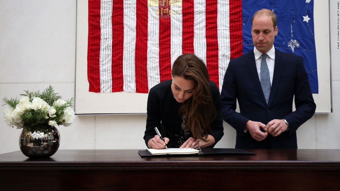 Britain&#39;s Prince William and his wife, Catherine, sign a book of condolences at the U.S. Embassy in London on June 14.