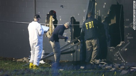 FBI agents investigate near the damaged rear wall of the Pulse Nightclub where Omar Mateen allegedly killed at least 50 people on June 12, 2016 in Orlando, Florida. The mass shooting killed at least 50 people and injuring 53 others in what is the deadliest mass shooting in the country&#39;s history.  