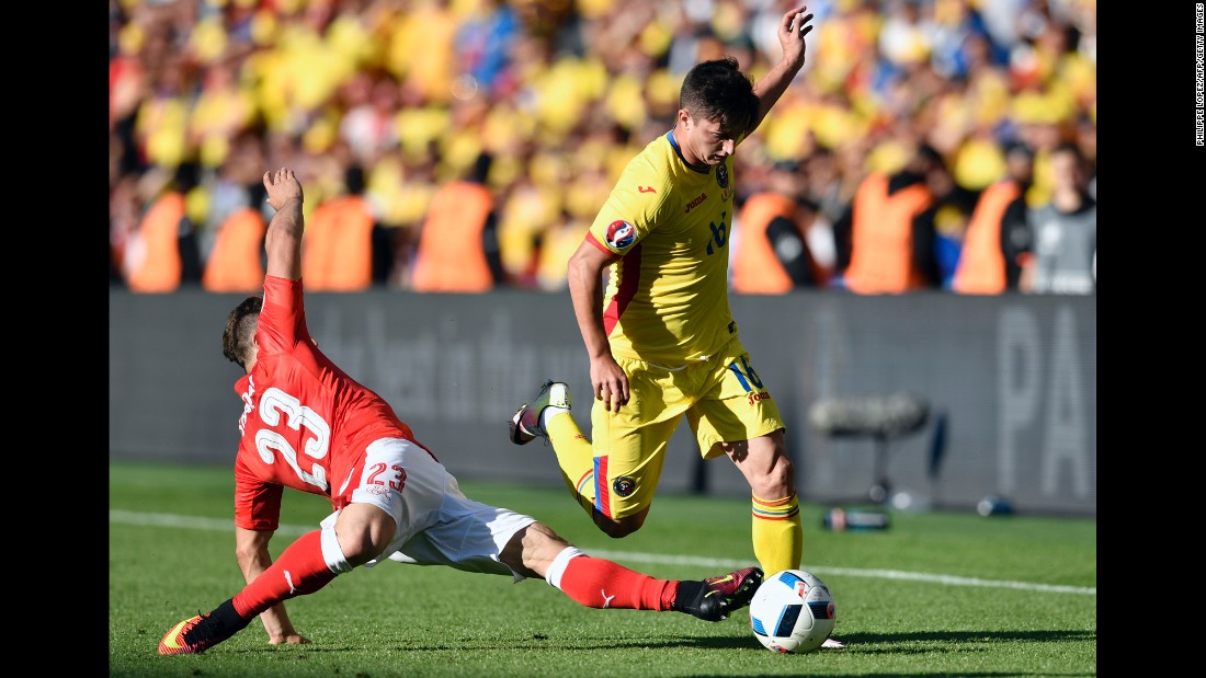 Romanian defender Steliano Filip is challenged by Switzerland&#39;s Xherdan Shaqiri.