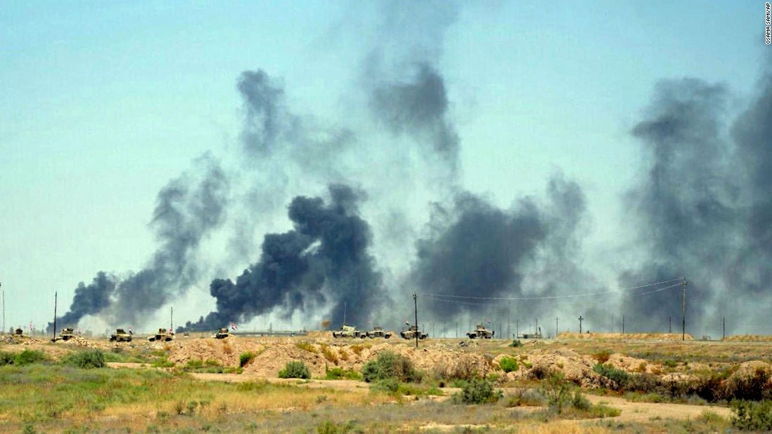 Smoke rises after airstrikes by U.S.-led coalition warplanes on Sunday, June 12.