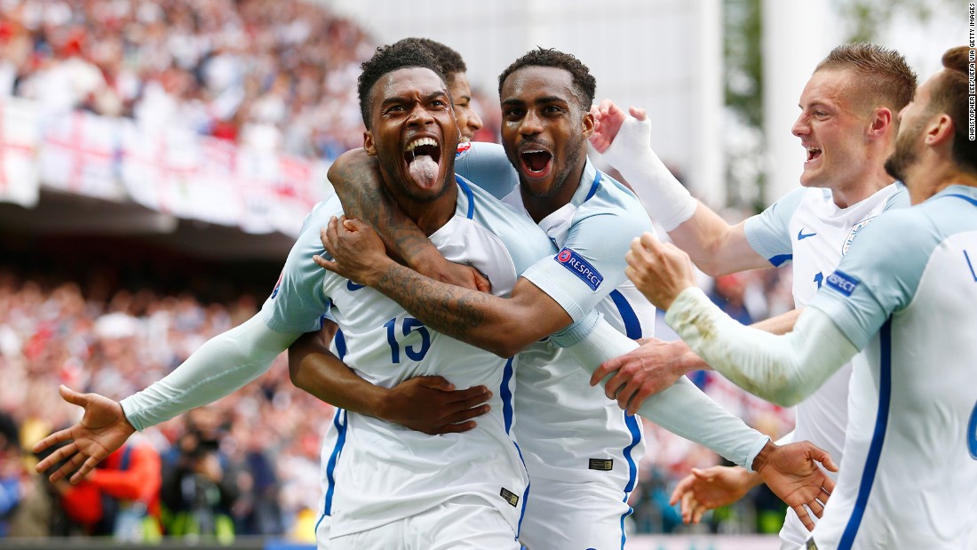 Daniel Sturridge, left, is mobbed by his England teammates after scoring a stoppage-time winner against Wales in Lens, France. England won 2-1.