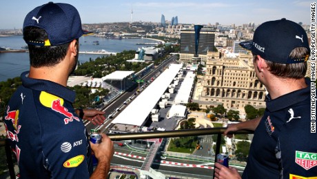 Red Bull Racing&#39;s Daniel Ricciardo and Max Verstappen look down on the Baku City Circuit