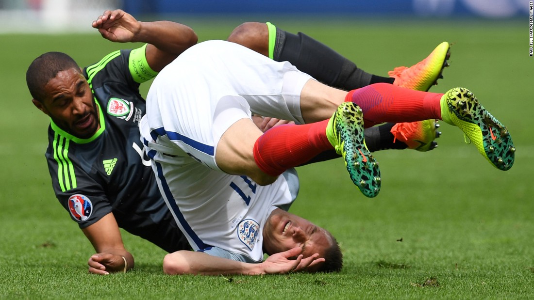 Vardy falls over after colliding with Welsh defender Ashley Williams.