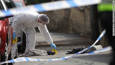 Forensic police examine the scene of the attack.