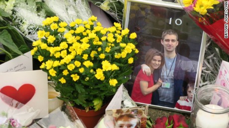 A photo of slain MP Jo Cox and her husband outside the British Prime Minister&#39;s residence lies amid floral tributes in Birstall, the northern English town where she was killed. 