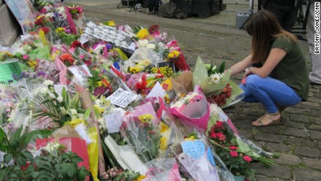 A woman lays flowers at a memorial to MP Jo Cox in Birstall.