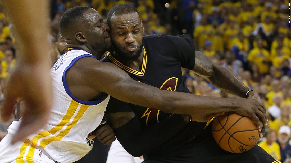 James is defended by Draymond Green in the second half.