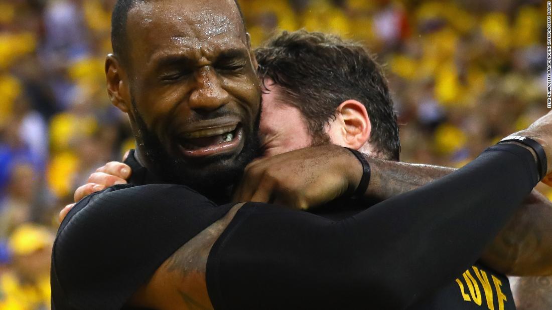 An emotional James hugs Love after Cleveland defeated Golden State to win the title in 2016.