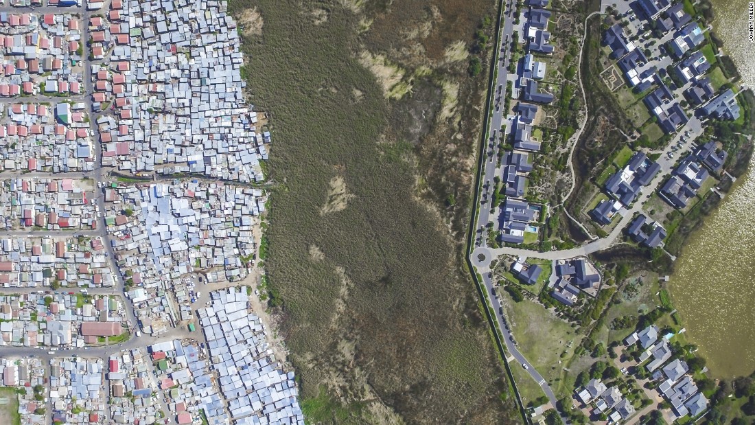 Pictured are the neighboring areas of Masiphumelele and Lake Michelle. Although Masiphumelele was not set up during apartheid, it is a former township. &lt;br /&gt;&quot;Black people lived in these areas usually fenced off or somehow separated from other areas through buffer zones such as highways, green belts, train tracks or rivers,&quot; notes Miller.