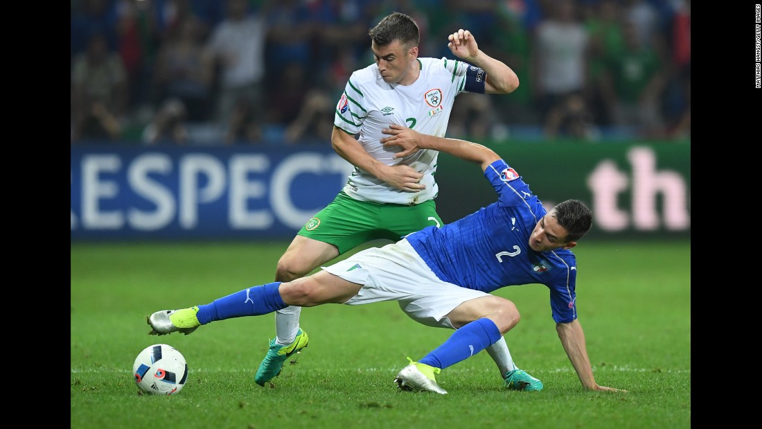 Ireland&#39;s Seamus Coleman, top, battles Italy&#39;s Mattia De Sciglio for possession of the ball.