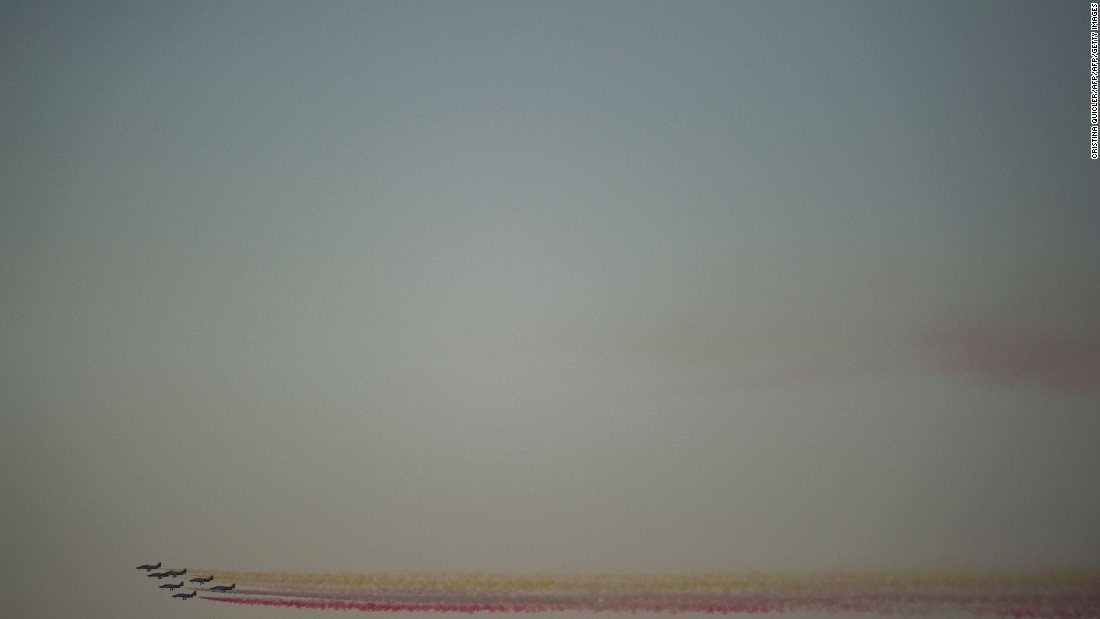 The Spanish Air Force&#39;s Patrulla Aguila formation team performs past the sun-powered Solar Impulse 2 aircraft arriving few moments before landing at Sevilla airport on June 23, 2016.