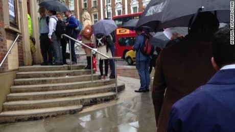 Voters line up in the rain to cast their votes in West Hampstead, London.