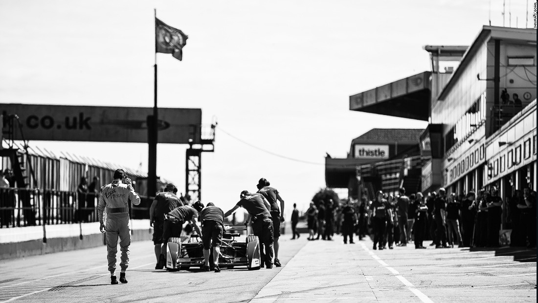 A Formula E car is wheeled back along the pit lane at the UK&#39;s Donnington Park circuit. 