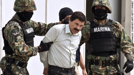 Guzman is escorted by marines as he is presented to the press on February 22, 2014 in Mexico City. 