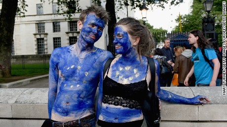 LONDON, ENGLAND- JUNE 24: A young couple painted as EU flags protest on outside Downing Street against the United Kingdom&#39;s decision to leave the EU following the referendum on June 24, 2016 in London, United Kingdom. The United Kingdom has gone to the polls to decide whether or not the country wishes to remain within the European Union. After a hard fought campaign from both REMAIN and LEAVE the vote is too close to call. A result on the referendum is expected on Friday morning.  (Photo by Mary Turner/Getty Images)