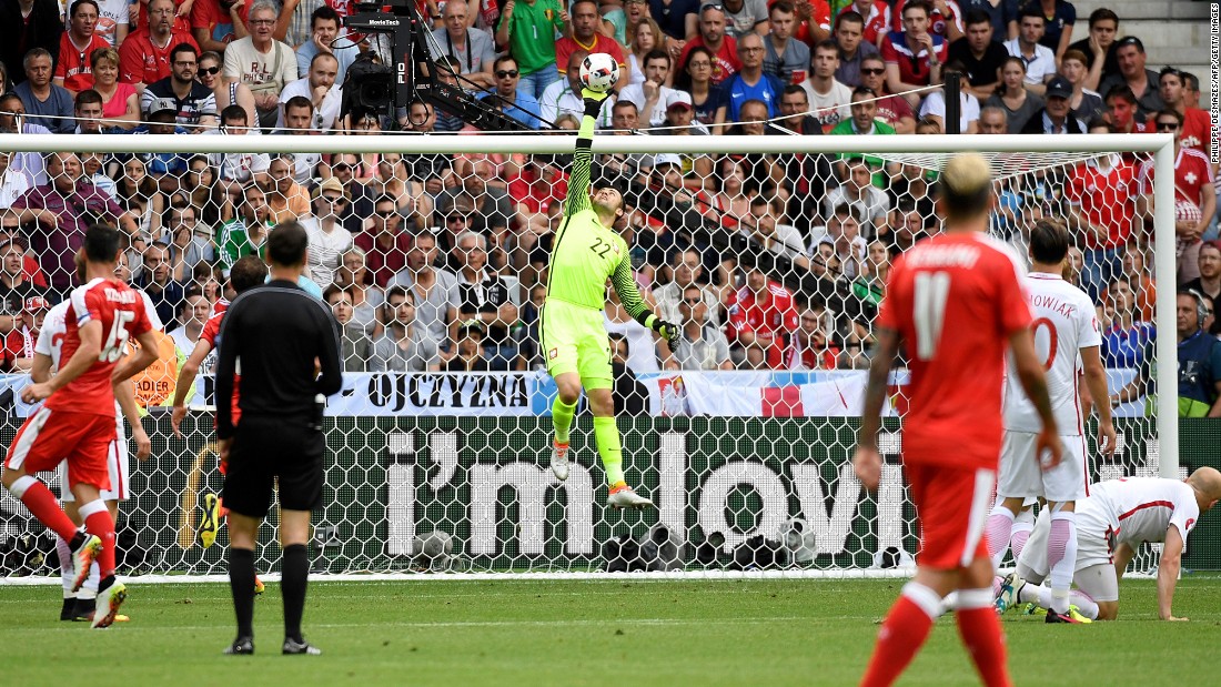 Poland goalkeeper Lukasz Fabianski, center, makes a save.