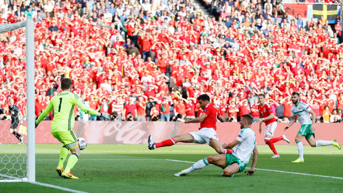 Gareth McAuley, third right, of Northern Ireland scores an own goal past Michael McGovern, first left.