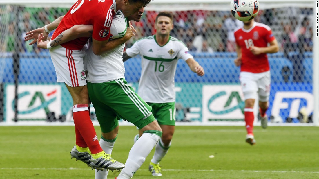 Wales defender James Chester, left, challenges Northern Ireland forward Kyle Lafferty.