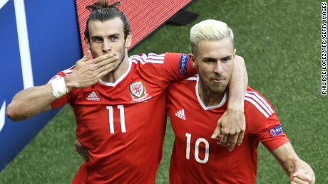 Gareth Bale (left) and midfielder Aaron Ramsey celebrate after an own goal by Northern Ireland&#39;s defender Gareth McAuley put their side ahead at the Parc des Princes.