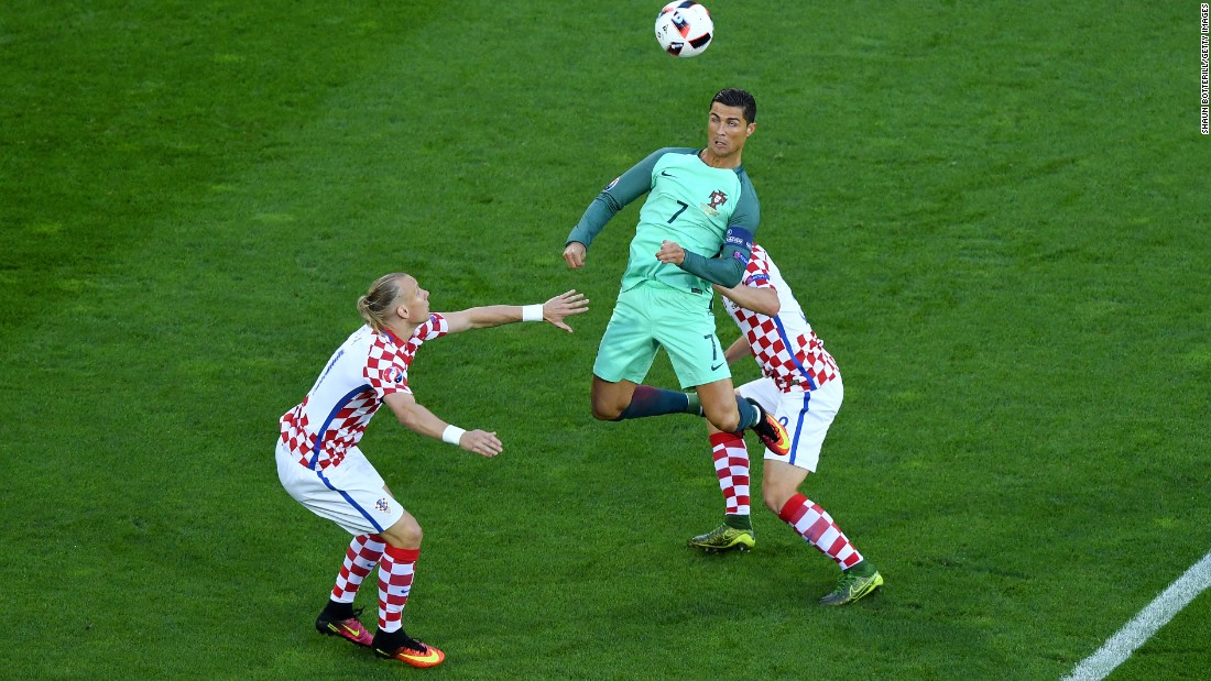 Cristiano Ronaldo, center, of Portugal heads the ball under pressure of Domagoj Vida, left, and Ivan Strinic, right, of Croatia.