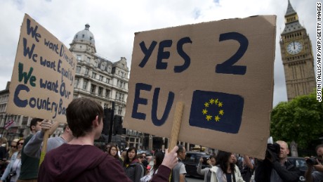 A demonstrator holds a placard during a protest against the outcome of the UK&#39;s June 23 referendum on the European Union (EU), in central London on June 25, 2016.