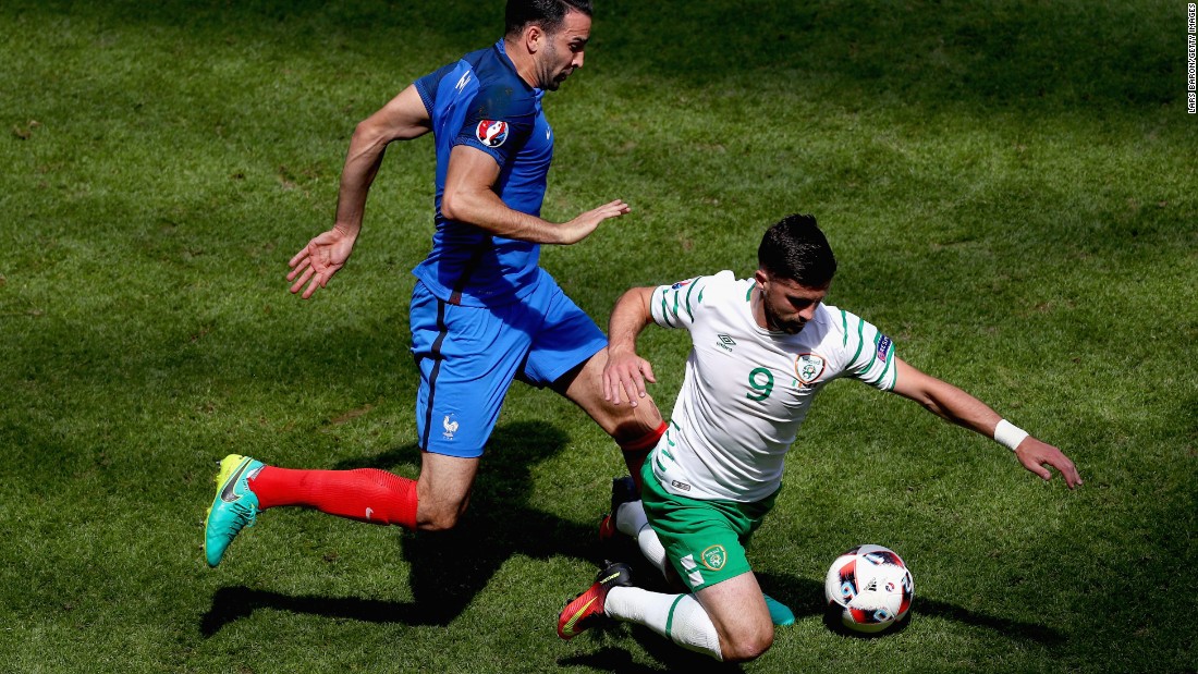 Adil Rami of France fouls Shane Long of Ireland, resulting in a yellow card.