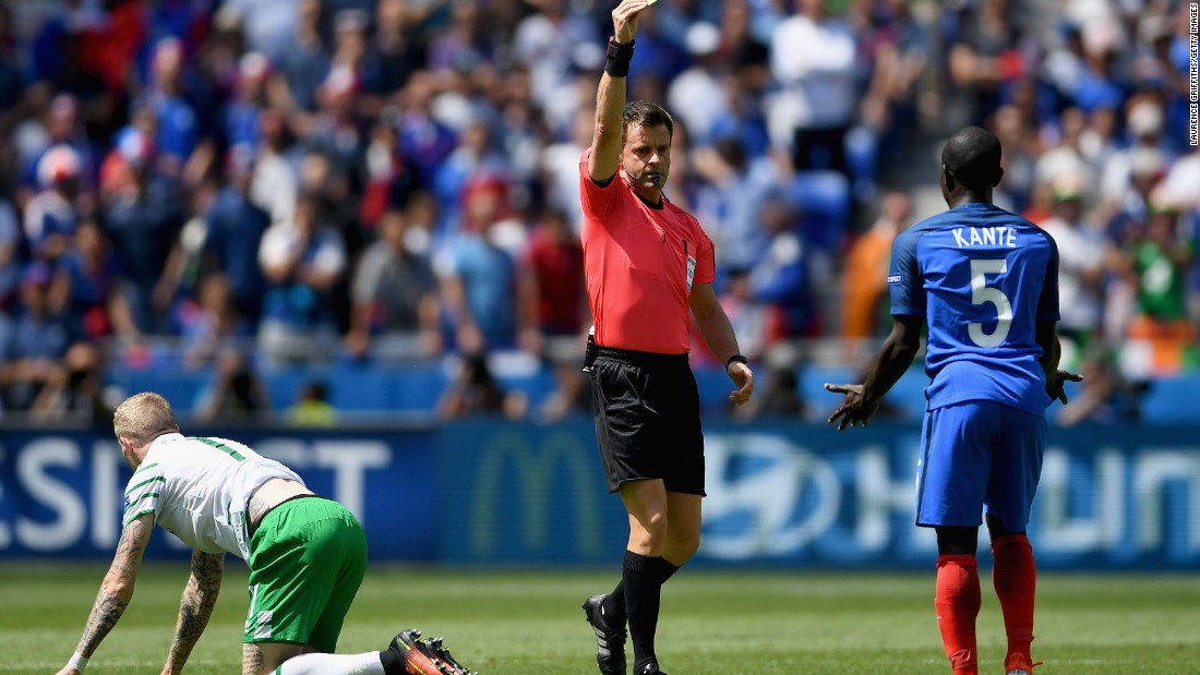 N&#39;Golo Kante of France is shown a yellow card by referee Nicola Rizzoli after fouling James McClean of Ireland.
