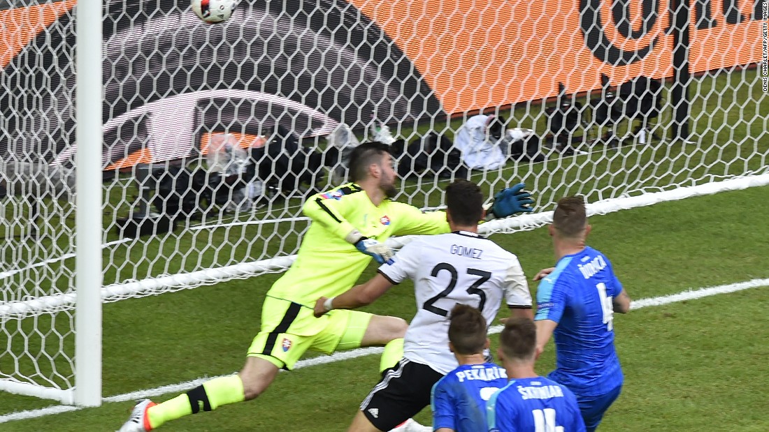 Germany&#39;s forward Mario Gomez, center, scores against Slovakia&#39;s goalkeeper Matus Kozacik.