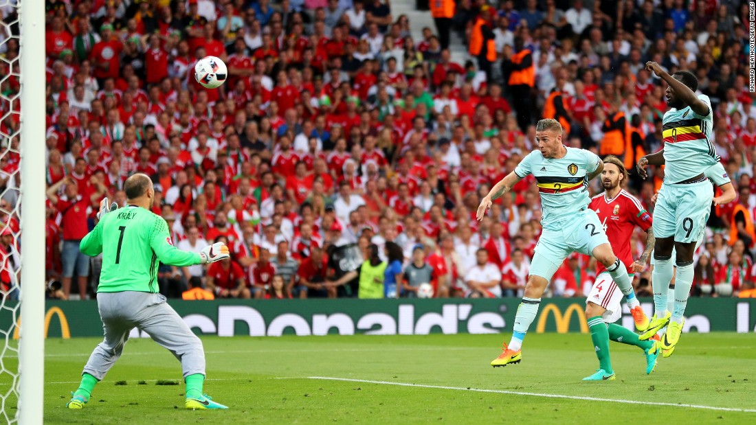 Toby Alderweireld, center, of Belgium heads the ball to score the opening goal past Gabor Kiraly, left, of Hungary.