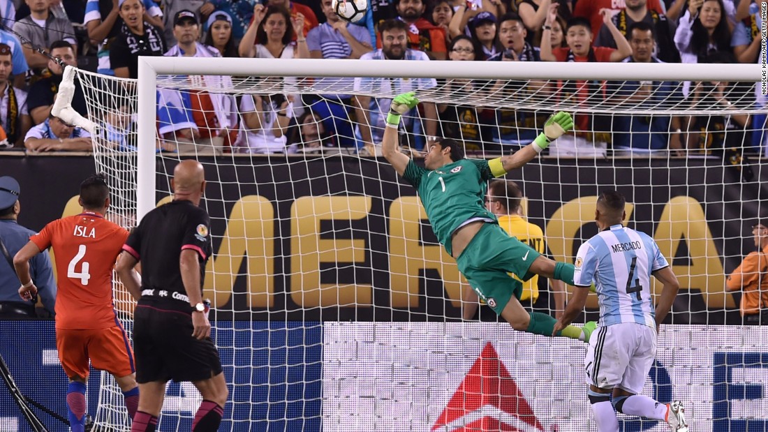 Chile&#39;s goalkeeper Claudio Bravo pulls off a save following a header by Argentina&#39;s Sergio Aguero (out of frame).